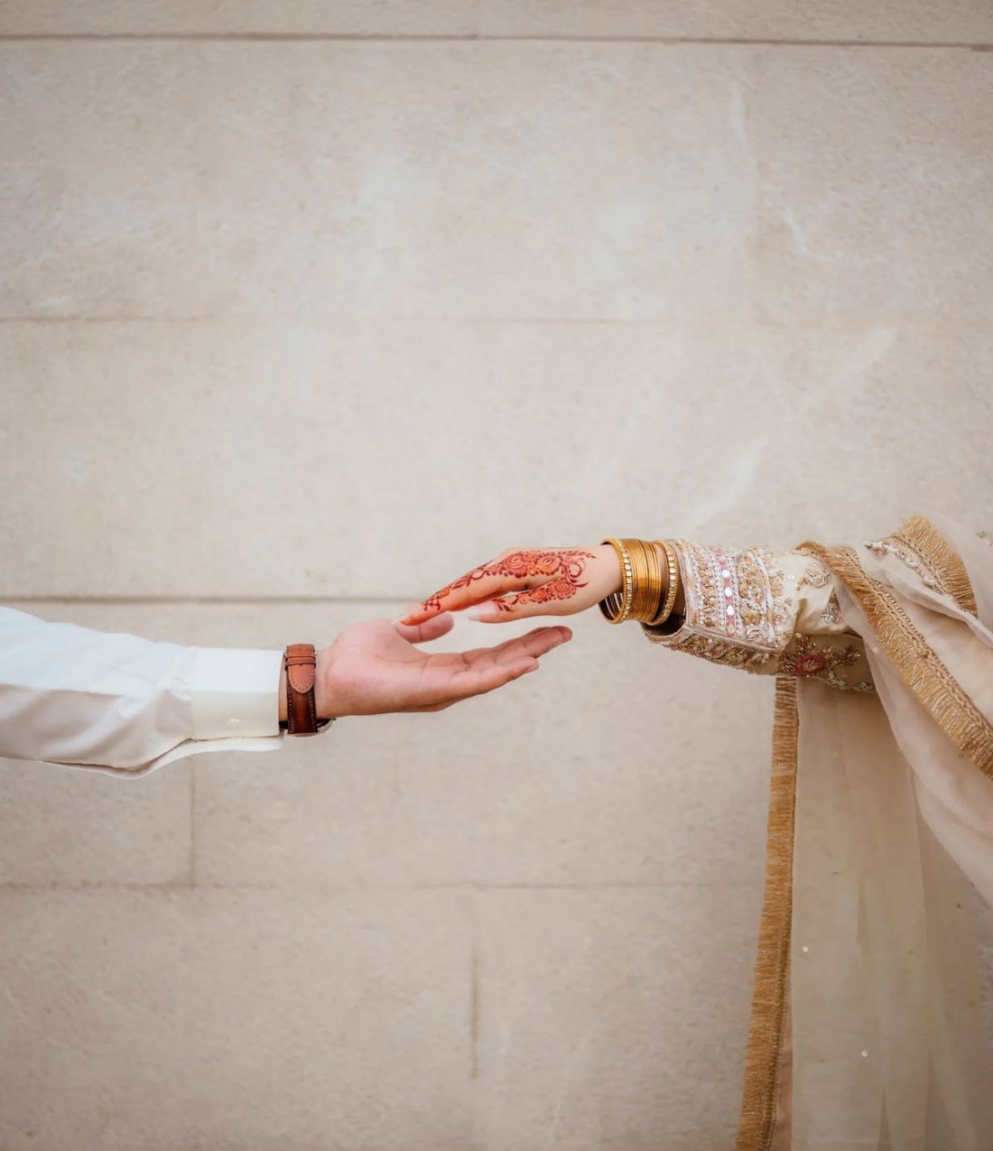 Bridal mehndi and hands reaching together